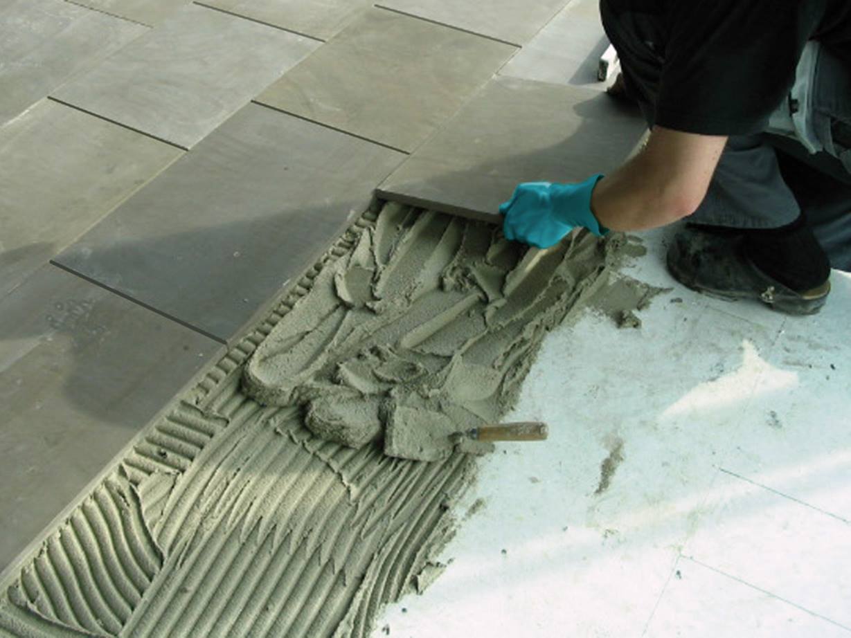 зображено процесс кладки плитки Ceramicplace на підлогу